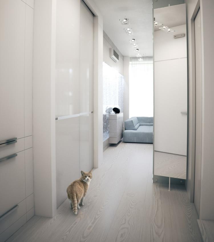white mirrored hall to living room with white walls along the corridor with ceramic floor tiles with storage cupboard in the wall